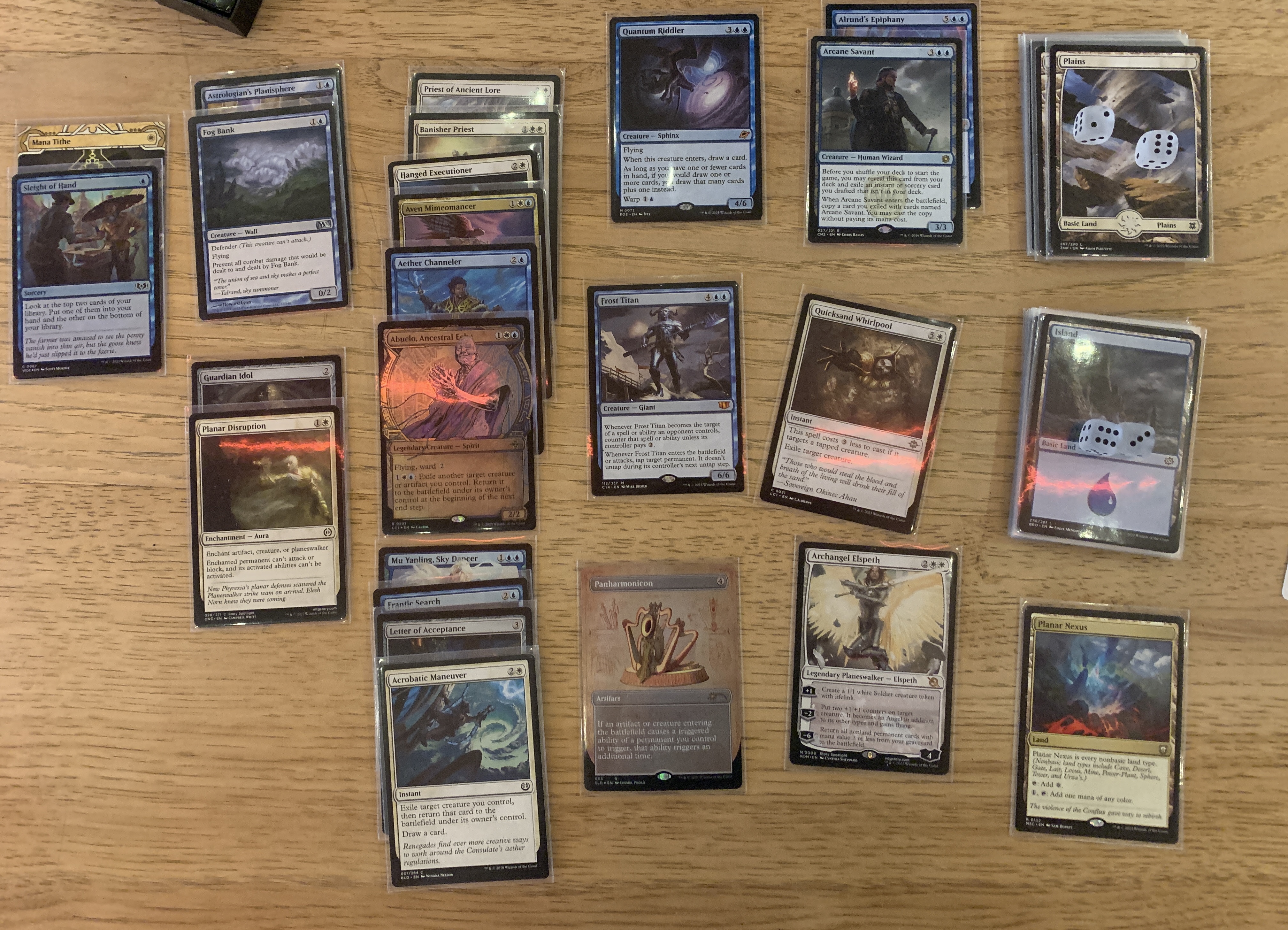 A deck picture of a UW blink deck, with a Alrund's Epiphany tucked under Arcane Savant for a turns package.