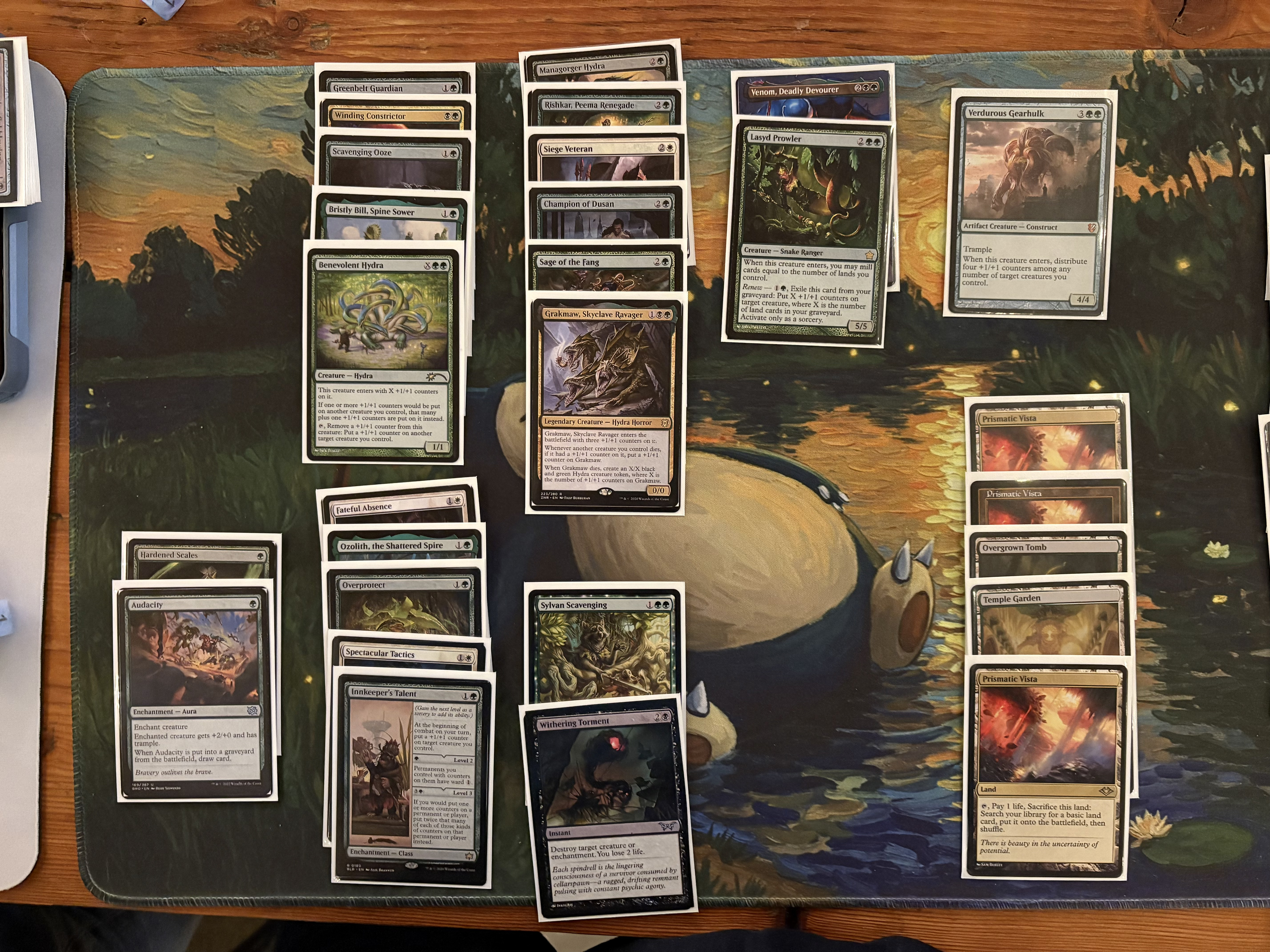 A deck picture of a base-green, splashing white and black, +1/+1 counters deck.