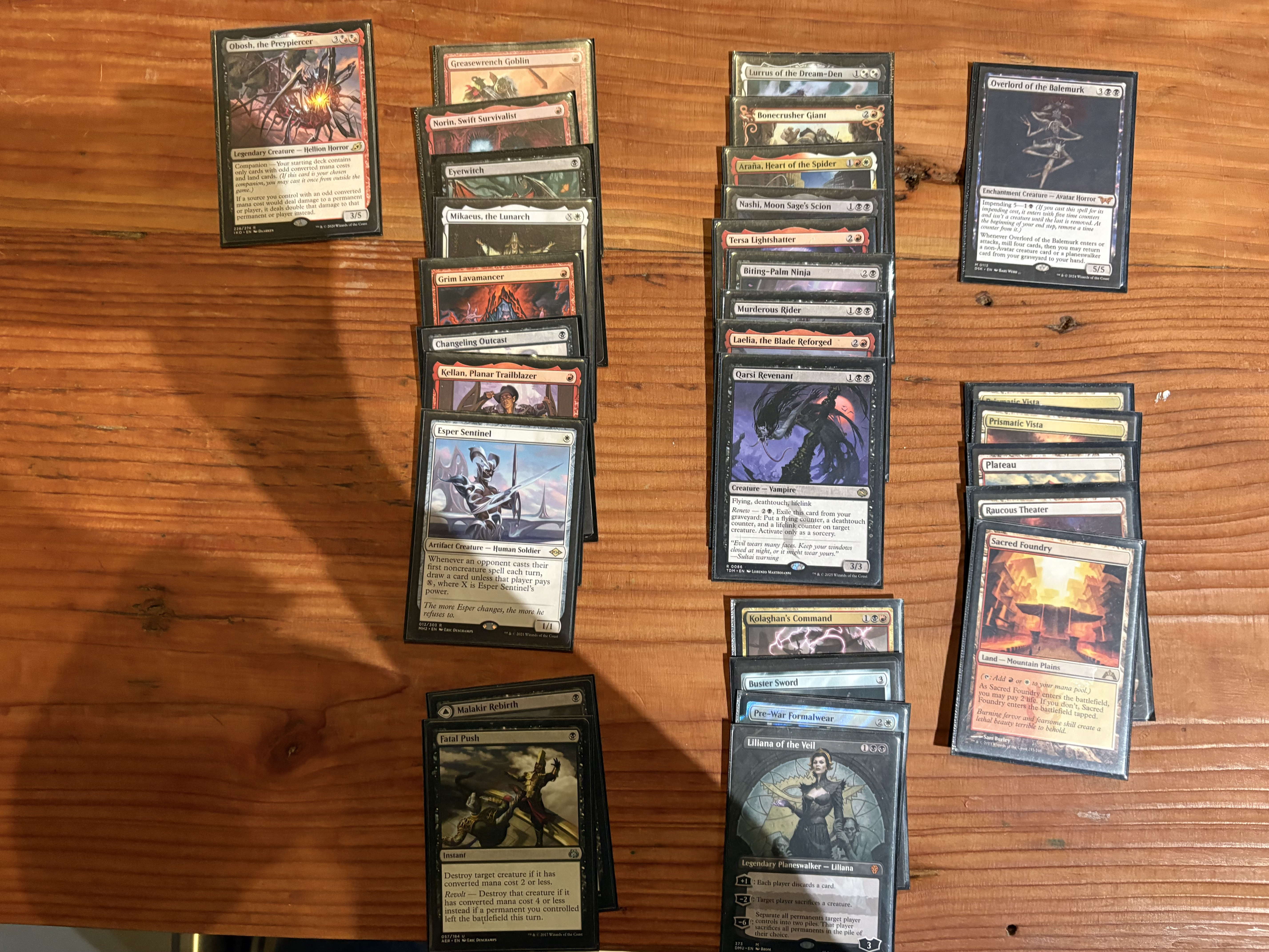A deck picture of my Rakdos splashing white aggro deck, companioning Obosh, the Preypiercer.