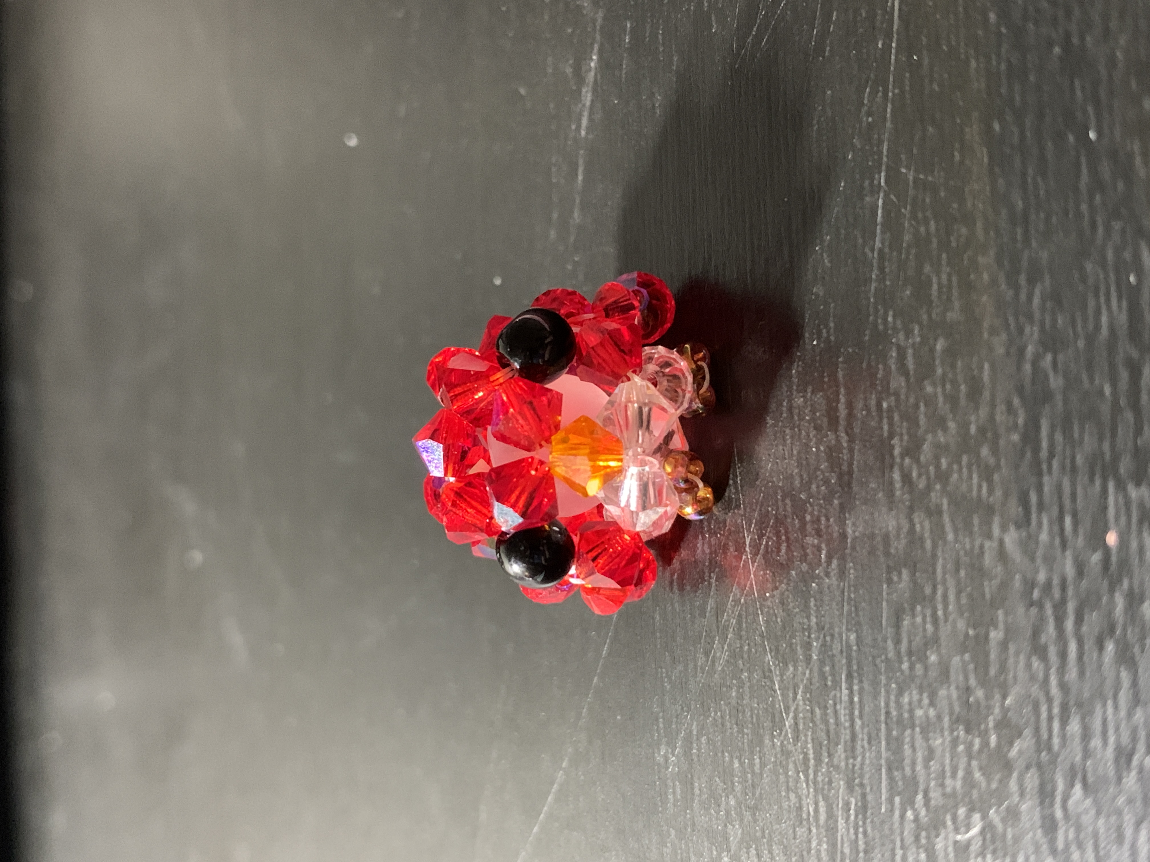 A picture of a red beaded bird.